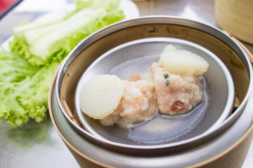 dim sum - steamed Minced pork with Scallop  in bamboo basket on