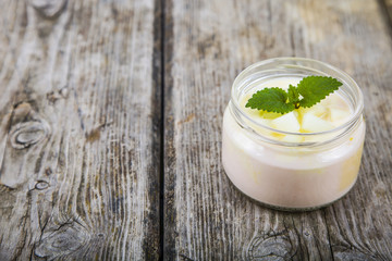 Yogurt with melon on a wooden table.