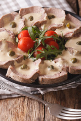 Italian Vitello tonnato with tuna sauce and capers close-up. Vertical
