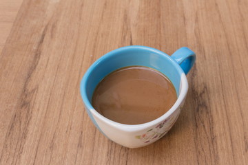 coffee in the morning on the wood table, select focus front cup