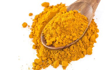 Turmeric powder in wood spoon on white background