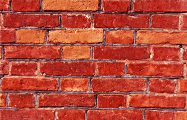 Weathered red brick wall surface.