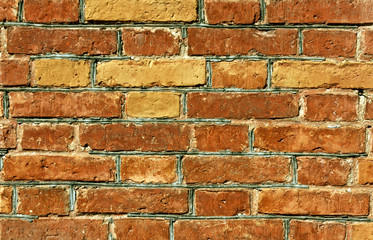 Weathered orange brick wall surface.