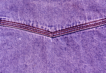 Violet jeans surface with stitch.