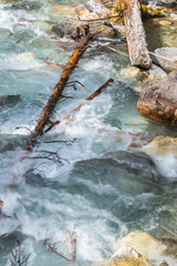 Turbulence. Turquoise and White Water over Rocks in River.  Vertical