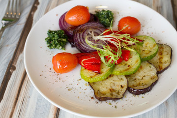 Gilled vegetables salad on wooden table