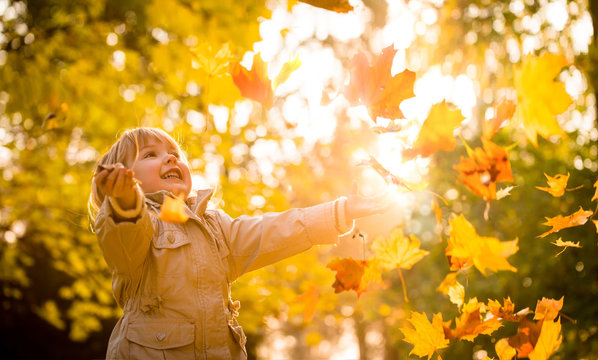 Child enjoying autumn time