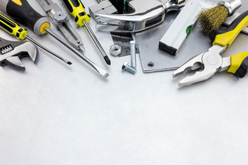 Fototapeta premium scratched metal background with yellow tool set and instruments for hand work and fixing