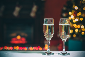 Two champagne glass on christmas bokeh background