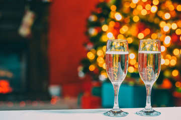 Two champagne glass on christmas bokeh background