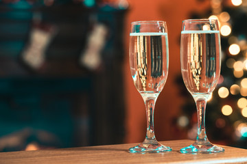 Two champagne glass on christmas bokeh background