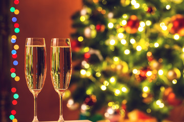 Two champagne glass on christmas bokeh background