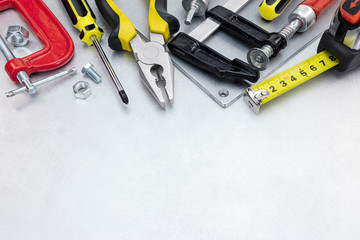 set of different tools and instruments for house renovation and construction on scratched metal background