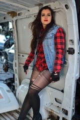 brunette girl posing in a car scrappage