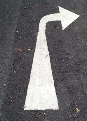 white turn right arrow sign painted on asphalt road, direction traffic signs