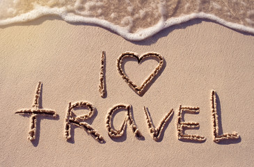 I love travel handwritten on the sand