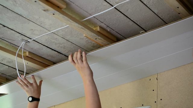 Two Workers makes the ceiling of MDF panels