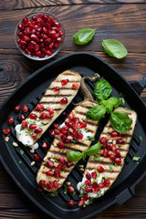 Roasted eggplant slices with pomegranate seeds and sour cream