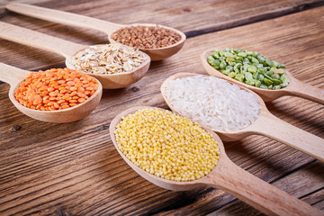Assortment of cereals in wooden spoons