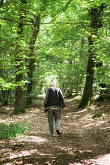 Old man walk in the forest