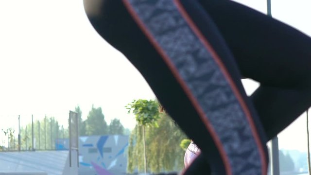 Two sexy girls doing exercises with weights outdoor. Slowly