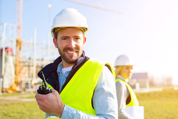 Two workers working outside on a construction site