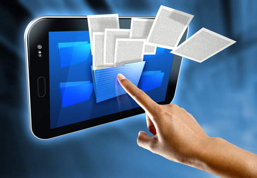A woman's finger select a folder on a digital tablet
