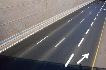 Lane and arrow marks on highway, showing the traffic lanes and direction.