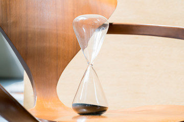 hourglass on wooden background.
