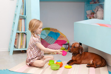 The little girl at the picnic with the dog