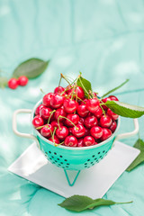 fresh red cherry fruit green colander