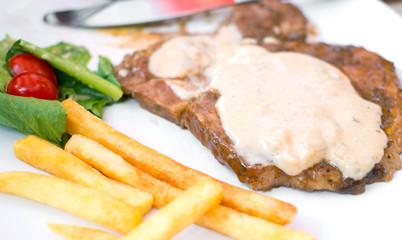 porkchop steak, frenchfried and salad