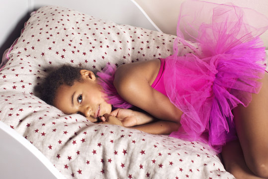 Portrait of girl lying on bed at home