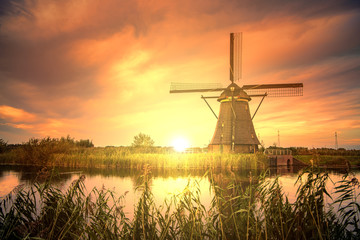 Beautiful sunset over Kinderdijk windmill, Unesco world heritage monument, Alblasserdam, Netherlands © Ankor light