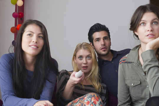 Friends watching movie at home together