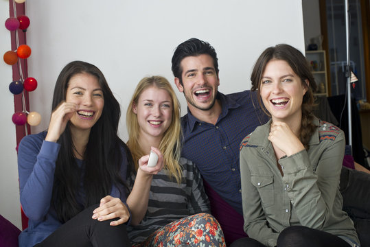 Friends watching movie at home together