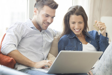 Couple at home shopping online together