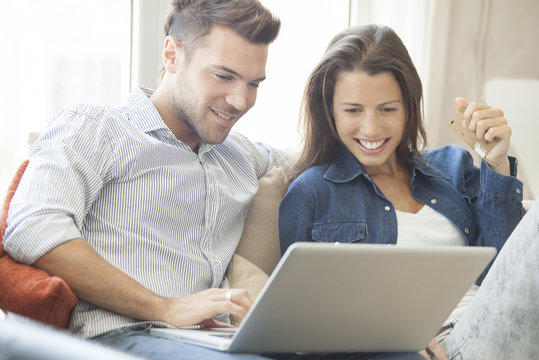 Couple at home shopping online together