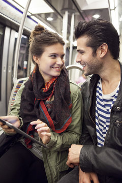 Young couple riding subway together
