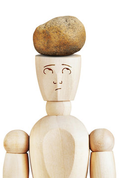 Heavy stone lies on the human head. Troubles and depression. Abstract image with a wooden puppet