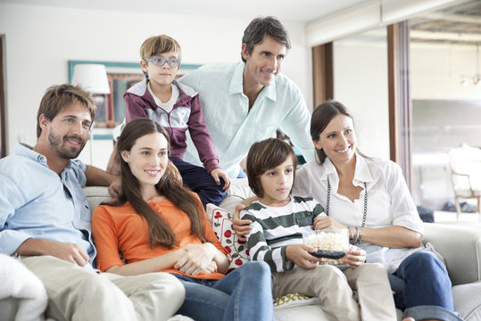 Extended family watching TV together