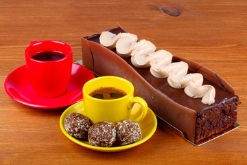 chocolate cake with two cup of coffee and chocolate balls on woo