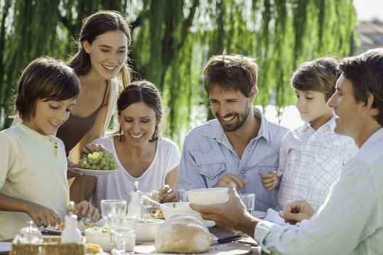 Family enjoying breakfast together outdoors