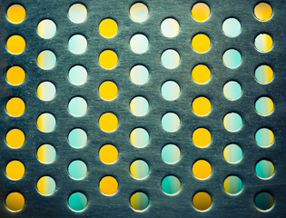 metallic surface with colorful holes