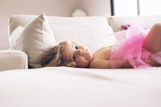 Portrait of girl lying on bed at home