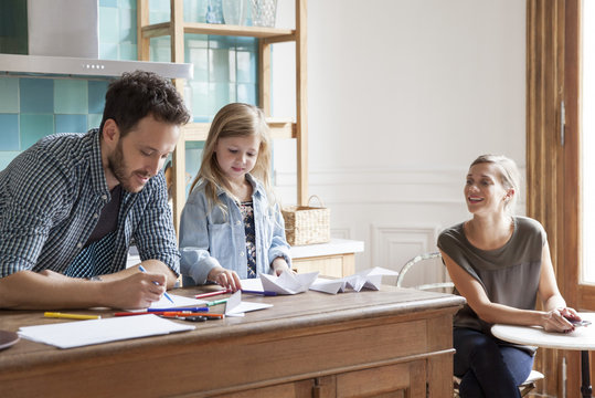 Parents spending time with young daughter at home
