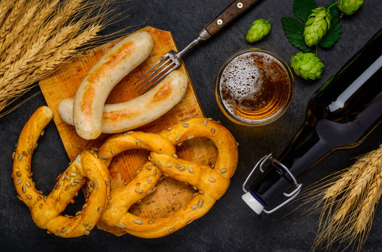 Prezel with Grilled Sausages and Glass Beer