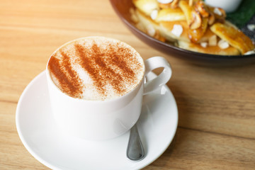 hot capucino on wood table, vintage effect