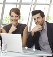Businessman and businesswoman with laptop computer