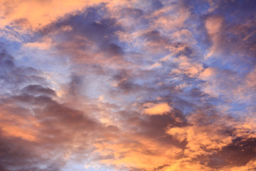Naklejka na ściany i meble Fiery sunset with orange cloud and blue sky